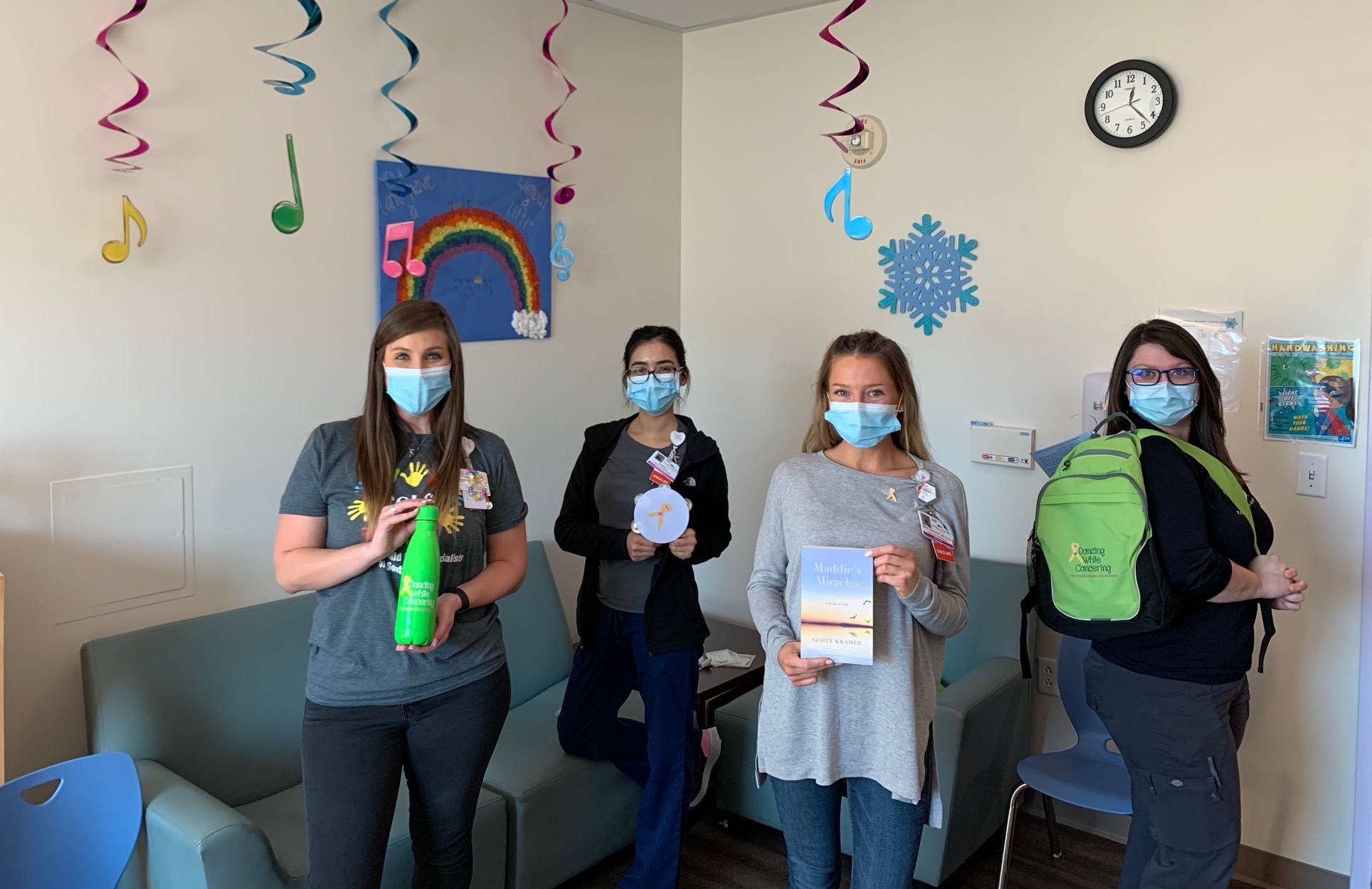 Four ladies holding fun goodies following a “Dancing While Cancering” Zoom debut