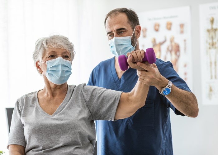 Woman doing physical therapy with doctor