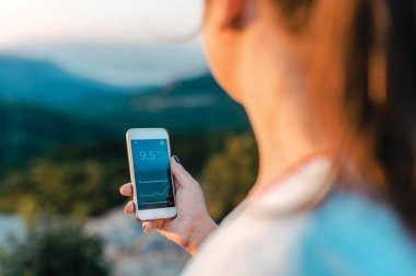 Woman looking at health app on mobile screen