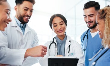 A group of medical residents discussing a chart