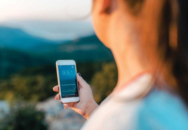 Woman looking at health app on mobile screen