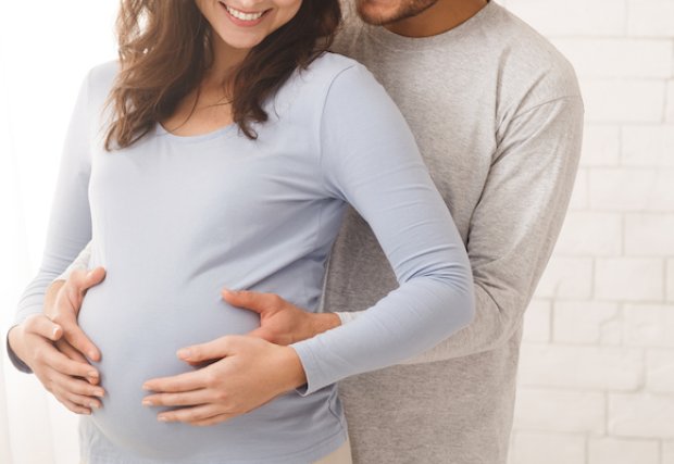Man hugging his pregnant wife