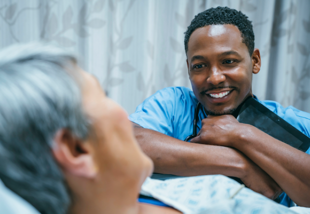 Male nurse treating a female patient