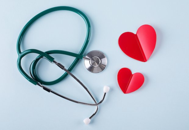 A stethoscope and some cutout hearts