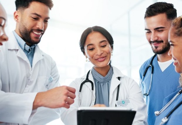 A group of medical residents discussing a chart