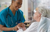 Nurse holding a patient's hand