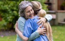 An older woman and younger woman hugging each other