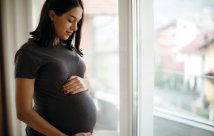 An expecting mother looking down at her belly