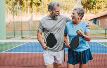 A man and woman playing pickleball