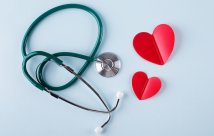 A stethoscope and some cutout hearts