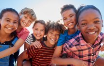 A group of children smiling at the camera.