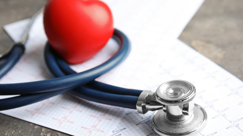 Cardiac test printous with a stethoscope and model heart.